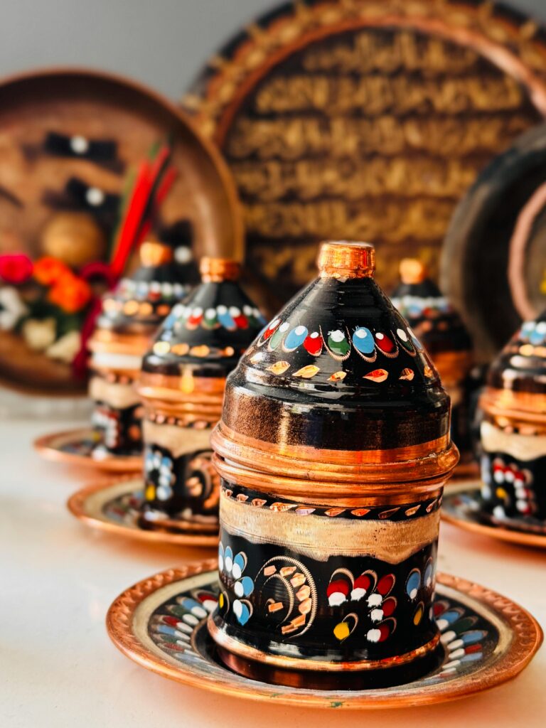 Vibrant hand-painted ceramic pots with intricate designs, perfect for traditional decor.